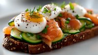 Gourmet open sandwich with smoked salmon, cucumber slices, poached egg, and fresh herbs on dark multigrain bread. Perfect for brunch or appetizer.