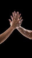 Two diverse hands high-fiving with water droplets, isolated on transparent background. Ready for design use on t-shirts, posters, stickers, sublimation, print-on-demand products, and digital graphics.
