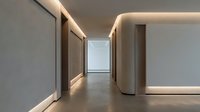 Modern minimalist hallway with warm LED lighting and clean architectural lines for contemporary interior design projects.