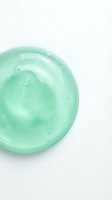 Green translucent gel texture with bubbles on white background for skincare and cosmetic product design applications.