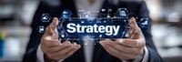 Business professional holding smartphone displaying strategy text with digital icons, modern technology interface concept for corporate planning and management.