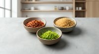 Three wooden bowls filled with colorful legumes and grains on kitchen counter. Healthy cooking ingredients for nutritious meals and plant-based recipes.