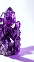 Purple amethyst crystal cluster with faceted geometric formations on white background for healing meditation and spiritual wellness decor.