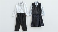 Classic school uniforms featuring white button-down shirts paired with black pleated skirt and dress pants on light background, ready for design and educational use.