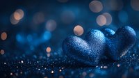 Sparkling blue hearts with glitter texture on dark background with soft bokeh lights creating romantic atmosphere for Valentine's Day designs.