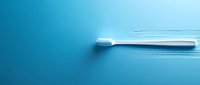 White toothbrush in motion against vibrant blue background, creating dynamic speed lines for dental hygiene and oral care concept.