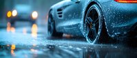 Luxury sports car on wet asphalt during rainfall, with water droplets and reflections creating dramatic atmosphere for automotive advertising.