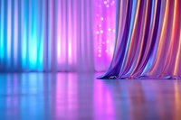 Elegant draped fabric in vibrant neon colors against blurred bokeh background with dramatic lighting and reflective surface creates dreamy atmosphere for fashion displays.