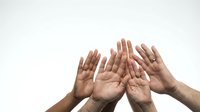 Diverse group of hands reaching upward together showing unity, teamwork and collaboration in community support and partnership concept.