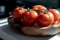 Fresh ripe red tomatoes on wooden bowl in kitchen setting with natural sunlight for healthy cooking and organic food preparation concepts.