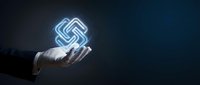 Businessman hand holding glowing neon swastika symbol on dark background. Suitable for historical, cultural, educational, and religious content.