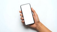 Hand holding modern smartphone with blank white screen mockup against light background for app presentation and digital marketing materials.