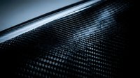 Carbon fiber material texture with glossy finish and detailed weave pattern for automotive and industrial design applications.