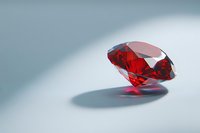 Brilliant red crystal gemstone floating with shadow on light background, luxury jewelry concept for precious stone and diamond advertising.