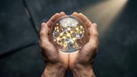 Hands holding glowing sphere with golden network connections representing global communication, innovation and digital transformation concepts.