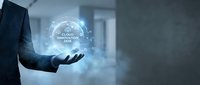 Businessman holding glowing cloud innovation network hologram with connected digital technology icons floating above palm in modern office environment.