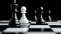 Black and white chess pieces on chessboard with dramatic lighting and shallow depth of field, creating contrast between opposing pawns in strategic gameplay position.
