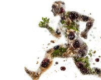 Athletic male figure in motion created from natural elements, combining running silhouette with scattered leaves, soil particles and organic matter on white background.