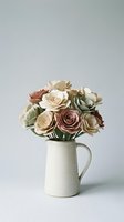 Handcrafted paper flower bouquet in ceramic pitcher with roses and succulents in neutral earth tones for home decor and crafting projects.