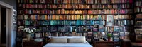 Panoramic view of cozy bedroom with floor-to-ceiling bookshelves filled with colorful books, comfortable bed, and soft ambient lighting creating warm atmosphere.