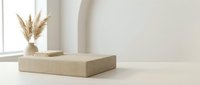Minimalist beige platform display with dried pampas grass in ceramic vase on neutral background for product presentation and modern interior design.