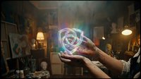 Hands holding glowing holographic geometric sphere with rainbow light effects in mystical workshop setting for futuristic technology and magic concepts.
