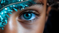 Close-up of bright blue eye with long eyelashes and glowing turquoise decorative elements creating magical atmosphere for beauty and fashion concepts.