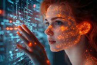 Young woman interacting with futuristic holographic interface, orange digital particles overlay on face, cybernetic visualization against blue tech background.