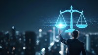 Businessman holding glowing digital scales of justice hologram against city skyline at night representing legal technology and law firm innovation.