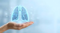 Human hand holding glowing blue lungs hologram on light background for medical healthcare respiratory system concept and pulmonary health awareness campaigns.