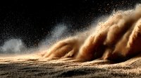 Dramatic sandstorm with swirling dust clouds and particles against dark sky creating powerful natural weather phenomenon for environmental concepts.