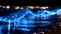 Glowing blue ocean wave at night with sparkling light effects and bokeh, creating magical seascape atmosphere for nature and fantasy backgrounds.