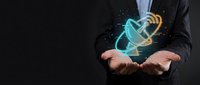 Businessman hands presenting glowing email envelope with digital effects on dark background for communication and technology concepts.