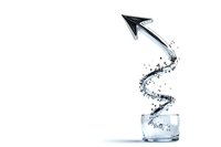 Water splashing from glass forming spiral path leading to black arrow shape against white background, creative liquid motion photography for advertising.