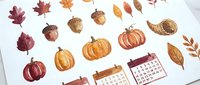 Watercolor autumn elements set with pumpkins, acorns, leaves and calendars isolated on transparent background for seasonal design projects.