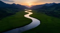 Meandering river curves through green valley at sunset, with dramatic mountain silhouettes and golden sky reflecting on calm waters. Aerial landscape view captures nature's serenity.