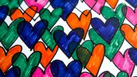 Colorful hand-drawn hearts pattern with vibrant markers creating playful romantic design for Valentine's Day cards, love-themed projects and decorative backgrounds.