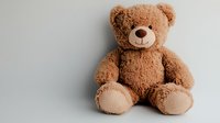 Fluffy brown teddy bear sitting against light background, soft plush toy with friendly smile and classic design for childhood, nursery and gift concepts.