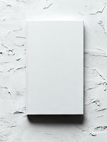Blank white book cover mockup on textured plaster wall background with natural design presentation.