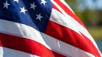 Close-up of waving American flag with stars and stripes in patriotic red white and blue colors for national holidays and celebrations.