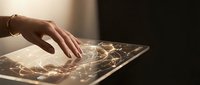 Hand touching illuminated digital tablet displaying glowing network connections and data visualization for technology, innovation, and digital transformation concepts.