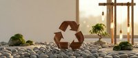 Wooden recycling symbol on pebbles with green plants in sustainable eco-friendly interior setting promoting environmental awareness and zero waste lifestyle.