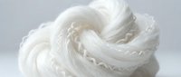 Soft white whipped cream or meringue swirl with delicate peaks and ridges, suitable for bakery, dessert, and food styling projects.