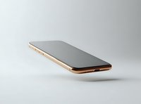Modern smartphone with gold frame floating in minimalist white studio setting against light background, showcasing sleek design and premium features.