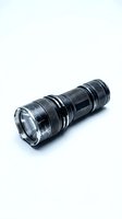 Black tactical LED flashlight with textured grip isolated on white background for emergency preparedness and outdoor adventure gear designs.