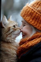 Senior woman in orange knit hat and scarf sharing tender moment with ginger cat, close-up portrait showing emotional bond between pet and owner in winter setting.