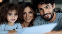 Happy mixed-race family with toddler daughter enjoying quality time together at home, smiling parents and child bonding in cozy living room setting.