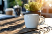 White coffee cup on wooden table with morning sunlight casting shadows through window blinds, creating atmospheric mood for breakfast or workspace setting.