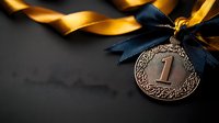 Bronze medal with ornate pattern and number one on dark background with gold and navy blue ribbon, symbolizing achievement and victory in competition or sports.