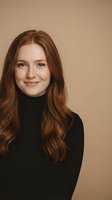 Young Caucasian woman with long wavy red hair wearing black turtleneck sweater smiling warmly at camera against neutral beige background.